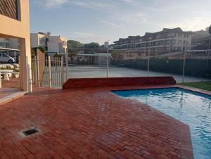 a brick patio with a swimming pool in front of a building at Chesapeake Bay 23 in Margate