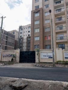 an empty street in front of a tall building at 1 Bedroom Apartment in Syokimau near Airport and SGR in Nairobi