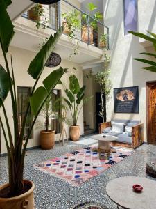 a living room with a couch and potted plants at Riad Kasbah 117 in Marrakech