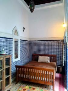 a bedroom with a bed and a blue tiled wall at Riad Kasbah in Rabat +21 photos