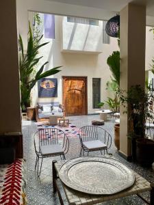 a living room with two chairs and a table at Riad Kasbah 117 in Marrakech