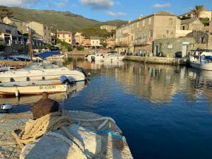 a group of boats are docked in a harbor at Maison ancienne rénovée avec vue sur mer et Cap Corse in Centuri