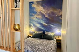 a bedroom with a cloud mural on the wall at Peaceful apartment in Cavaillon with garage in Cavaillon