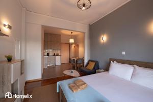 a bedroom with a bed and a living room at 30m² Cosy studio with panoramic sea view in Chalkida