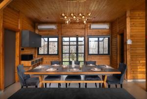 a dining room with a large wooden table and chairs at Stayscape Smultronstalle 6BHK Igatpuri in Zarvar