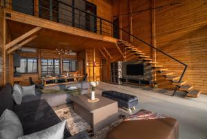 a living room with a couch and a staircase at Stayscape Smultronstalle 6BHK Igatpuri in Zarvar