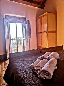 A bed or beds in a room at Case Rurali Pentedattilo