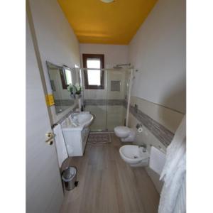 a bathroom with two toilets and a sink at Agriturismo Poggio all'Olivo in Follonica +33 photos