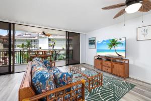 a living room with a couch and a table at Kona Alii#211 in Kailua-Kona