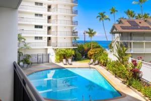 a view of the pool from the balcony of a resort at Kona Alii#211 in Kailua-Kona