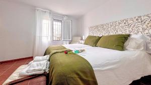 a bedroom with a large white bed with a headboard at Albaicin Rolando FreshApartment in Granada