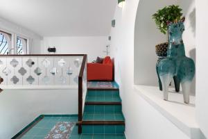 a staircase with green tile floors and a red bench at Estate4home - Suite Bonview in Massa Lubrense