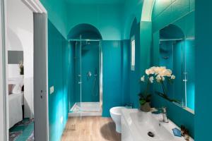 a blue bathroom with a sink and a shower at Estate4home - Suite Bonview in Massa Lubrense +39 photos