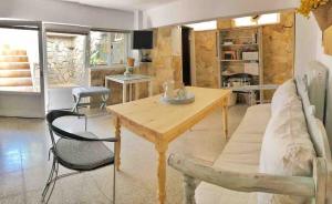a living room with a wooden table and chairs at Heraklion-Pinelopi Apartment in Ayía Marína