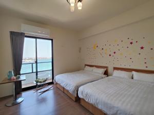 Postelja oz. postelje v sobi nastanitve Endless Summer Homestay