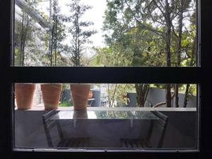 a window with a glass table with pots on it at Mona Lisa Guest House in Volos +26 photos
