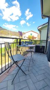 a patio with a table and chairs on a balcony at Casa Braida in Muro Lucano +3 photos