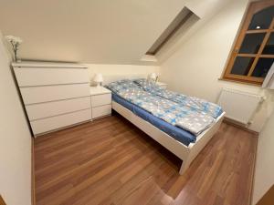 a small bedroom with a bed and a dresser at Vadrózsa Vendégház in Mátraszentistván +4 photos