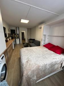 a bedroom with a large bed and a living room at Studio charmant à Fréjus avec piscine commune - 30 m² in Fréjus