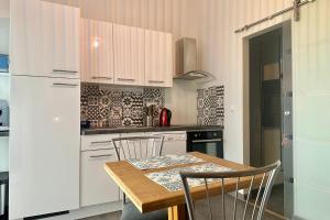 a kitchen with a wooden table and chairs in a kitchen at Peaceful apartment in Cavaillon with garage in Cavaillon
