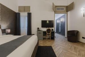 TV a/nebo společenská místnost v ubytování Casa Reale Boutique Hotel