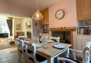 a dining room with a table and a clock on the wall at 45 Eskin Street in Keswick