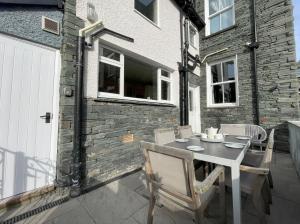 a table and chairs on a patio with a building at 45 Eskin Street in Keswick