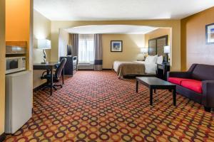 a hotel room with a bed and a couch at Quality Inn & Suites Montgomery East Carmichael Rd in Montgomery