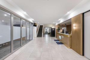 an office corridor with glass walls and a staircase at Comfort Inn Regal Park in Adelaide