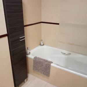 a bathroom with a bath tub and a sink at Apartamento Castellet1 in San Vicente de Castellet +11 photos