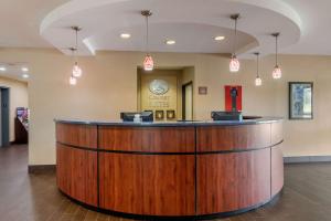 a lobby with a large wooden bar in a hospital at Comfort Suites Speedway - Kansas City in Kansas City +29 photos