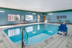 a large swimming pool with a blue chair in a room at Comfort Inn & Suites Emporia in Emporia