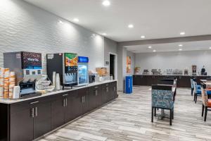 a restaurant with a counter and chairs in a room at Comfort Inn & Suites Emporia in Emporia