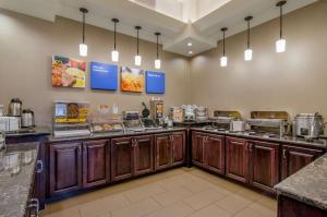 a large kitchen with a buffet line in a restaurant at Comfort Inn & Suites Shawnee - Kansas City in Shawnee