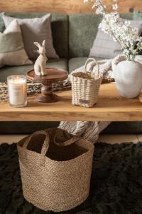 a living room with a couch and a table with baskets at Willa Podhalanka Jacuzzi & sauna - drewniany dom dla 20 osób in Biały Dunajec +154 photos