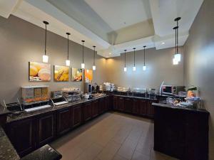 a large kitchen with a buffet line in a restaurant at Comfort Inn & Suites - Independence in Independence