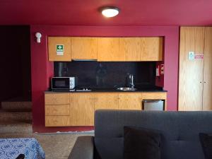 a kitchen with a couch in a living room at House 1 in Fafe