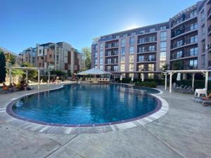 a large swimming pool in front of a building at Rainbow 3-213 Large Studio Delux in Sunny Beach