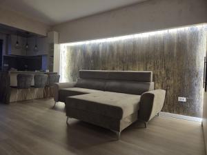 a living room with a couch and a table at Apartament Magheru Residence in Craiova