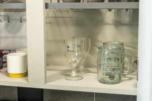 two wine glasses and a jar on a shelf at Gwangalli #Modern #Korea in Busan