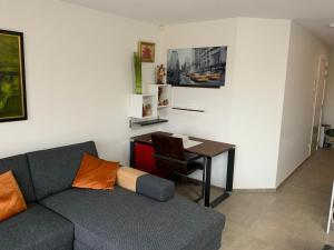 a living room with a couch and a table at La madeleine in De Panne