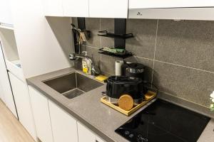 a kitchen counter with a sink and a microwave at Gwangalli #Modern #Korea in Busan