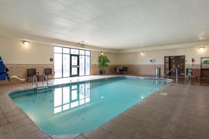 a large pool with blue water in a building at Comfort Inn & Suites Goodland in Goodland