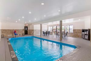 a swimming pool in a house with a dining room at Sleep Inn Olathe - Kansas City in Olathe