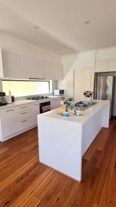 a large white kitchen with a white counter top at Cozy Room with Private Bathroom in Wheelers Hill