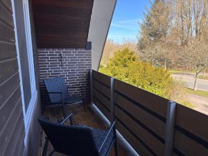 two chairs on a balcony with a view at Sky & Sand - Endless Sea I Hochwertige, stilvolle Wohnungen, Strandnah, Boxspringbett, mit Garten in Sankt Peter-Ording