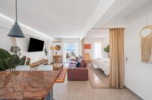 a living room with a couch and a bed at Pura Vida King-Size Bed Sea and Mountain view Apartment in Benalmádena