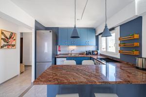 a kitchen with blue cabinets and a counter top at Pura Vida King-Size Bed Sea and Mountain view Apartment in Benalmádena
