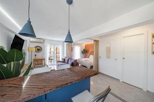 a kitchen and living room with a large counter top at Pura Vida King-Size Bed Sea and Mountain view Apartment in Benalmádena +21 photos