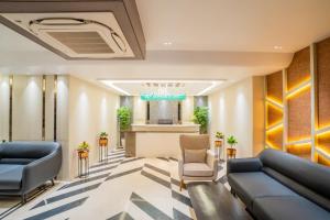 a lobby of a hotel with couches and chairs at Hotel SRH in Dhanbād